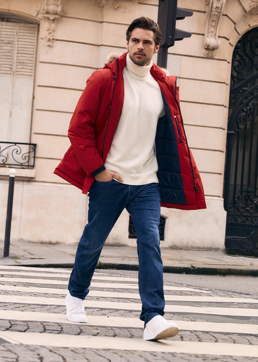 Creator Charly Man in red parka and jeans