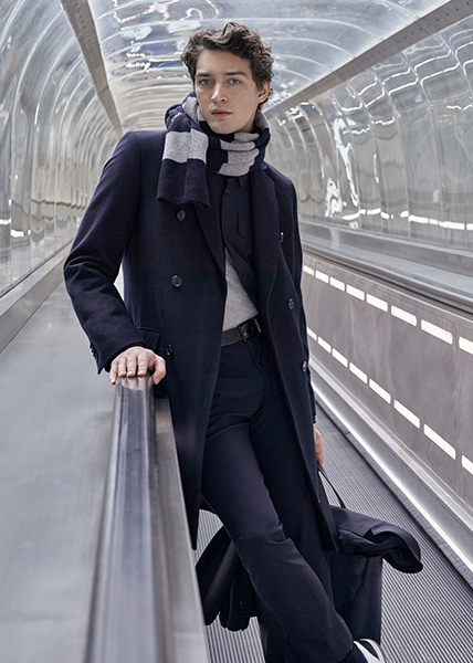Fashion culture from France Man on a escalator at the airport